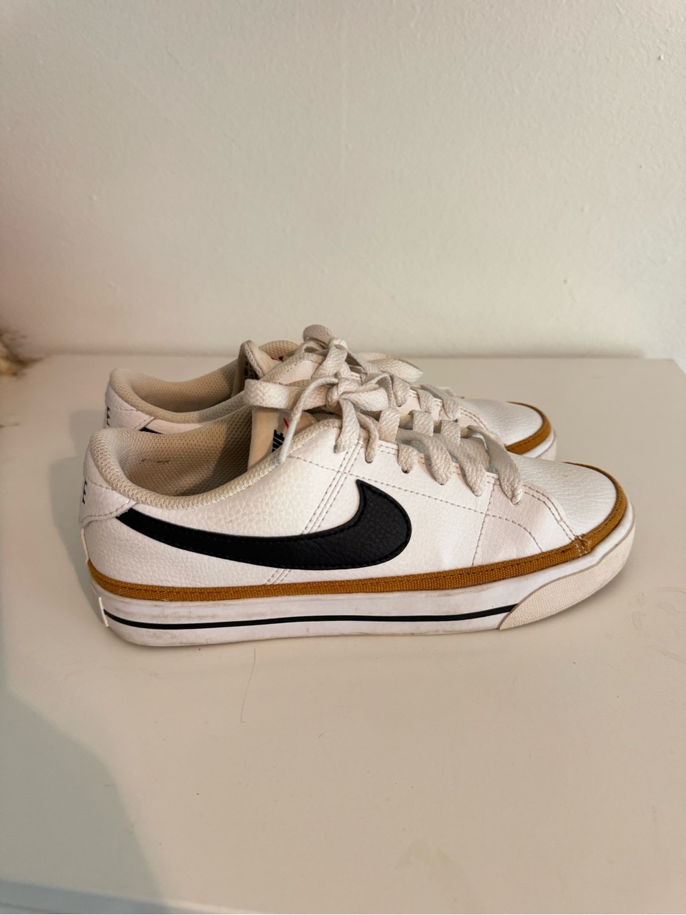 Nike White Low-Top Sneakers with Black Swoosh and Brown Trim